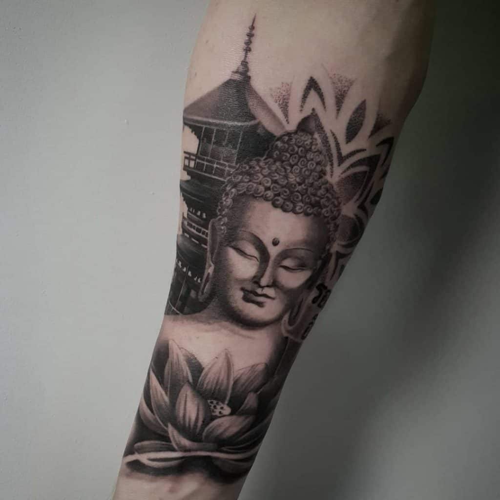 Black And Grey Ink Buddha Tattoo On Forearm
