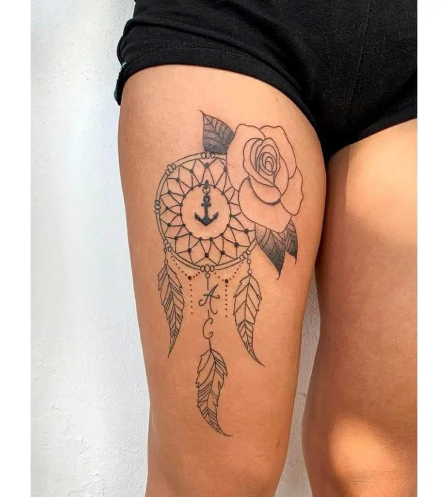 Rose Black Ink Dream Catcher Tattoo On Thigh 