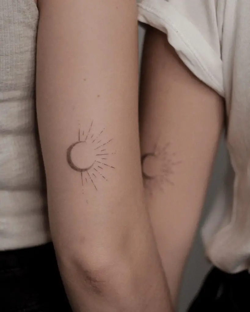 Sunshine lettering tattoo on the inner forearm