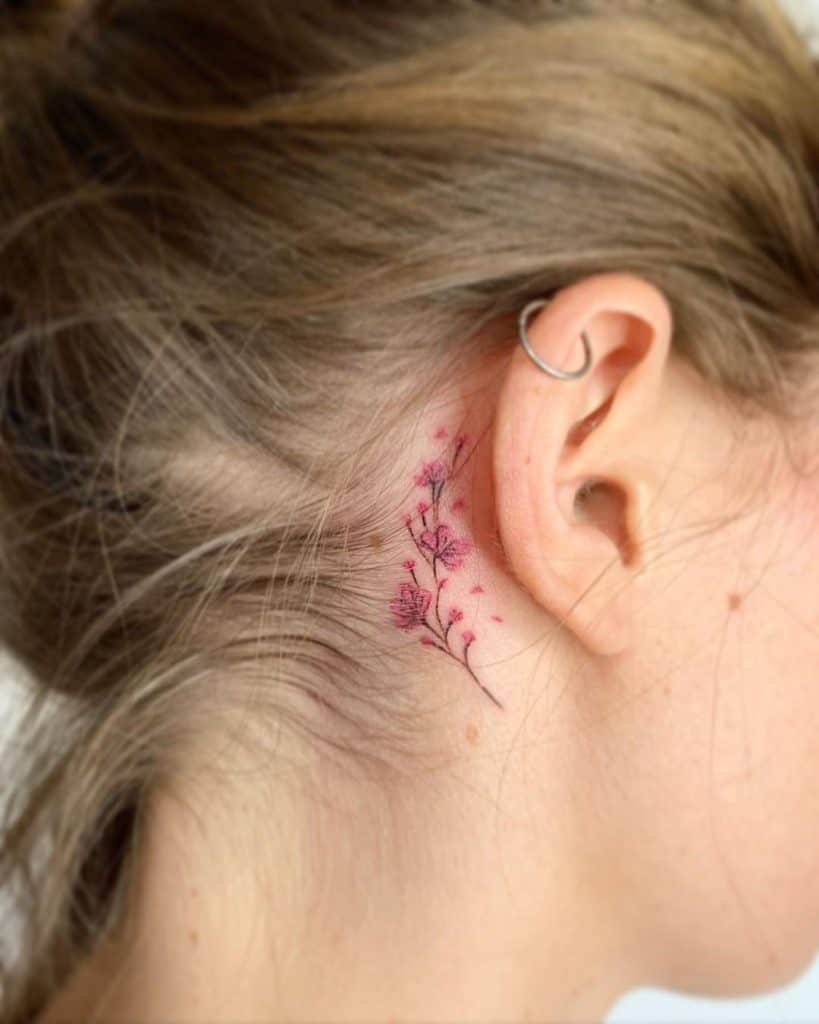 Simple dragon tattoo behind the ear by Brenda Kaye TattooNOW