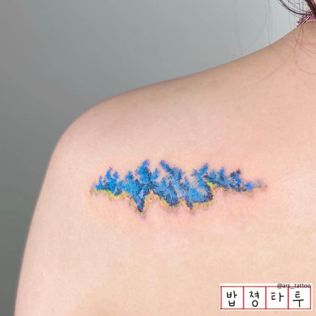 Small & Bright Blue Wave Shoulder Tattoo 