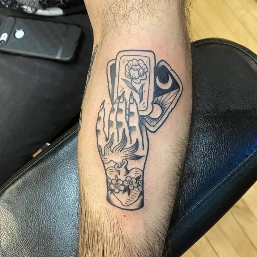 Tattoos with cards in hand
