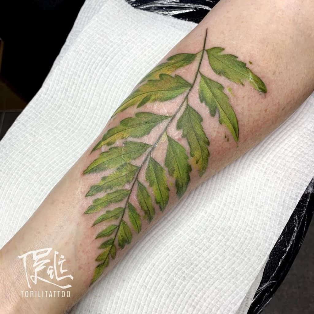 Minimalist green leaf ring tattoo