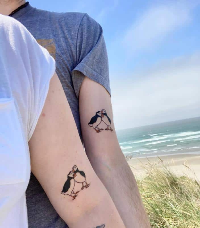 Matching couple tattoo of a minimalist wave