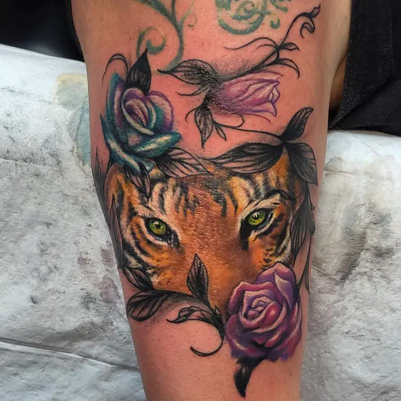 Tiger Eyes Behind Flowers Tattoo Design