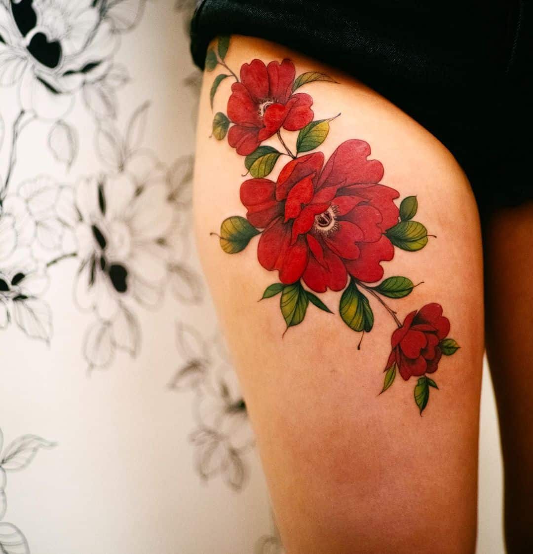 rose flower tattoo on thigh